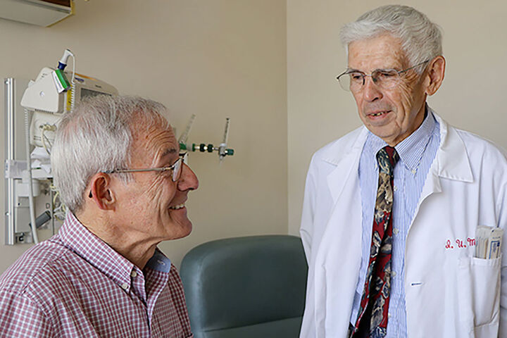 A doctor talks with a patient at a clinic.